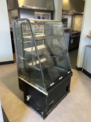 Structural Concepts 27" dry pastry display case in excellent condition. Tested and working. Glass front, multiple shelves.