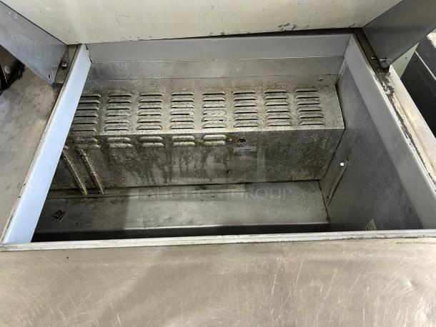 Continental Refrigerator SW60N24M-HGL prep table interior, showing metal surface condition. Two doors and 24 pan capacity.