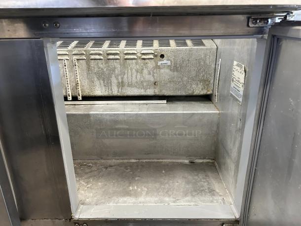 Continental Refrigerator SW60N24M-HGL inside view, showing spacious metal interior, shelves, and labels. Good condition.