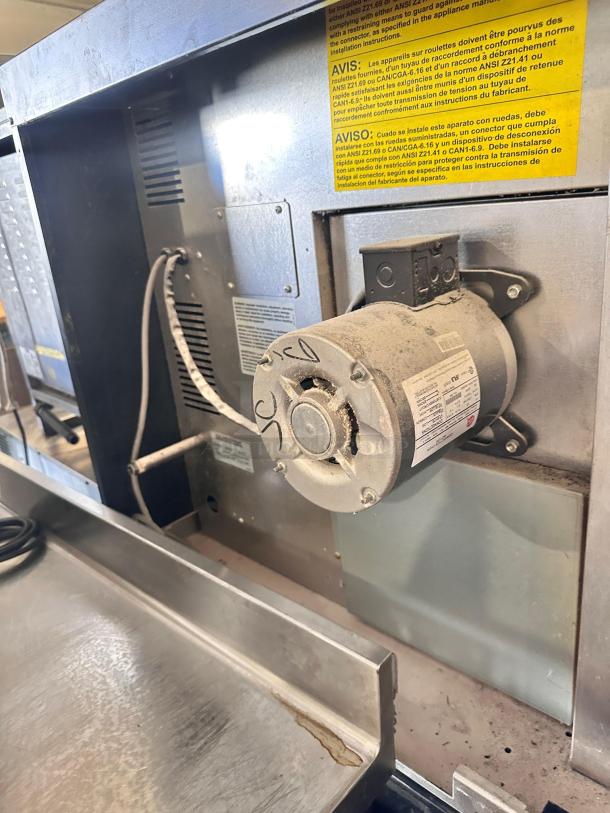 Southbend double-stack natural gas convection oven, superb condition, fully tested, standard depth, visible motor housing.