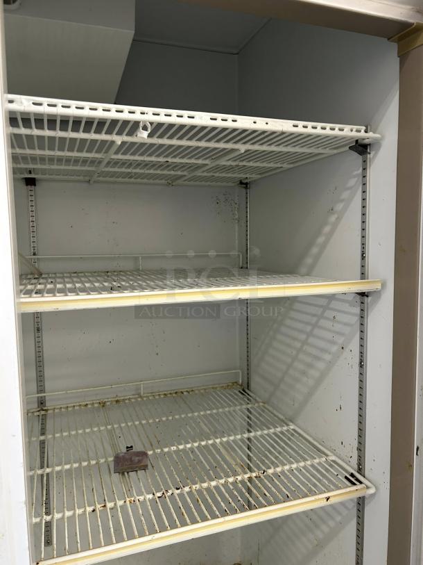 Blue Air BAGR72 3-door merchandising refrigerator interior, showing white wire shelves and slight rust, tested working condition.