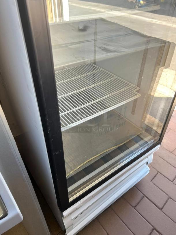 Everest EMGR24 single swing glass door refrigerator, tested and working, clean interior, visible wire shelves, minor exterior wear.