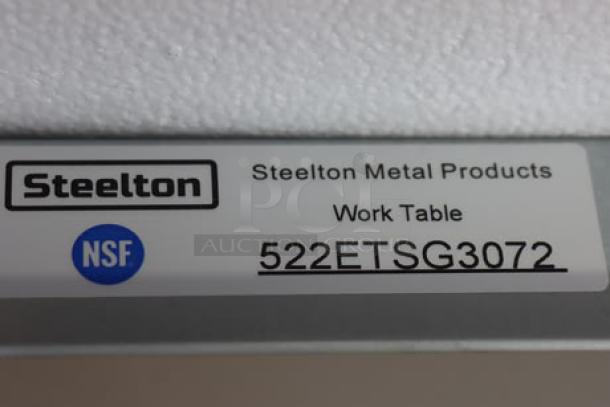 Steelton 30" x 72" stainless steel work table label, model 522ETSG3072, showing brand and NSF certification.