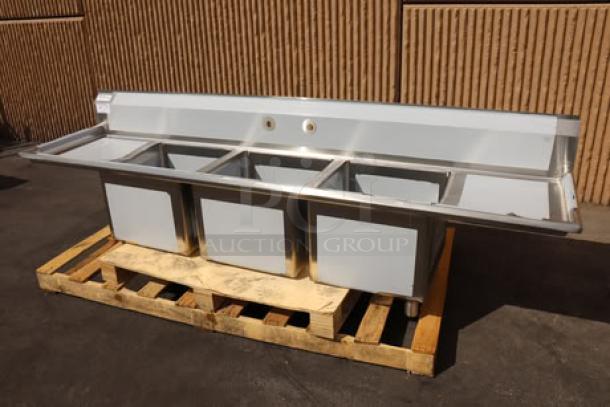Regency 600S31818218 stainless steel three-compartment sink, 94", 16 gauge, with cross bracing, 2 drainboards, minor scratches.