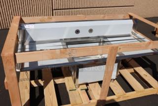 Regency 600S12323224 stainless steel two-compartment sink with galvanized legs, 96" with 23"x23"x12" bowls, new condition.