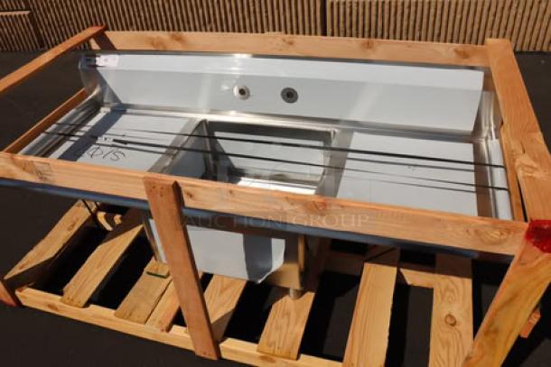 Brand new Regency 600S12323224 two-compartment sink, 96" stainless steel, 2 drainboards, potential scratches, on wooden crate.