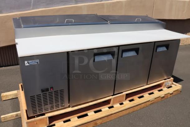 Brand new Avantco APPT-91-HC 92" 3-door refrigerated pizza prep table on pallet, stainless steel, minor cosmetic imperfections.