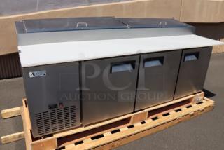 Brand new Avantco APPT-91-HC 92" 3-door refrigerated pizza prep table on pallet, stainless steel, minor cosmetic imperfections.