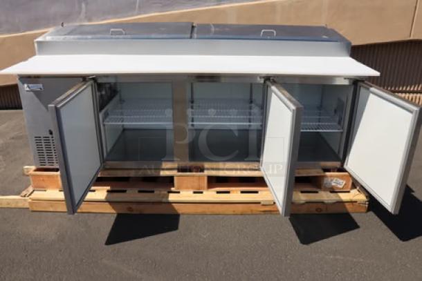 Avantco APPT-91-HC 92" three-door refrigerated pizza prep table, brand new with minor scratches, on wooden pallet.