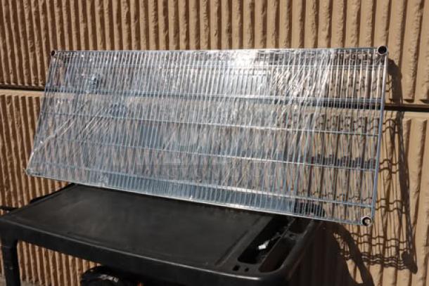 Two Regency 24" x 60" NSF chrome wire shelves, model 460EC2460, new but possibly scratched or dented.