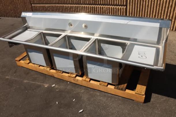 Regency 79" stainless steel sink, model 600S31515215, with three compartments and two drainboards, minor scratches.