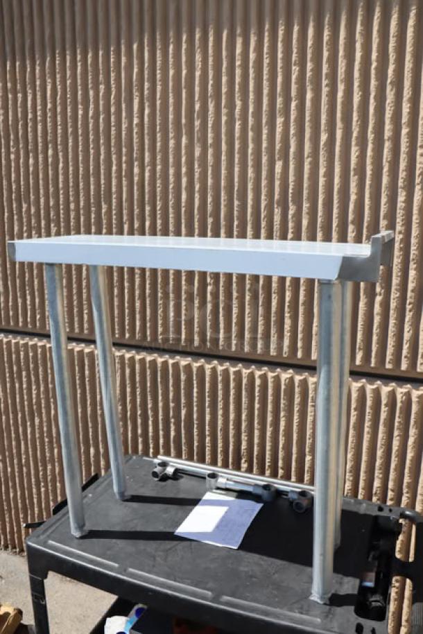 Regency 600WT12X36BS filler table, 36"x12", 16-gauge stainless steel, backsplash, new with minor scratches, damaged packaging.