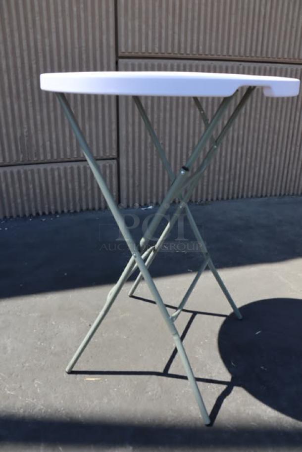 Brand new Lancaster 32" round granite white bar height folding table with sage gray legs. Packaging damaged.