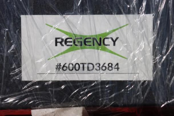 Regency 600TD3684 label on aluminum traffic door, brand new, shows model number. Door is 36"x84" with 9"x14" window.