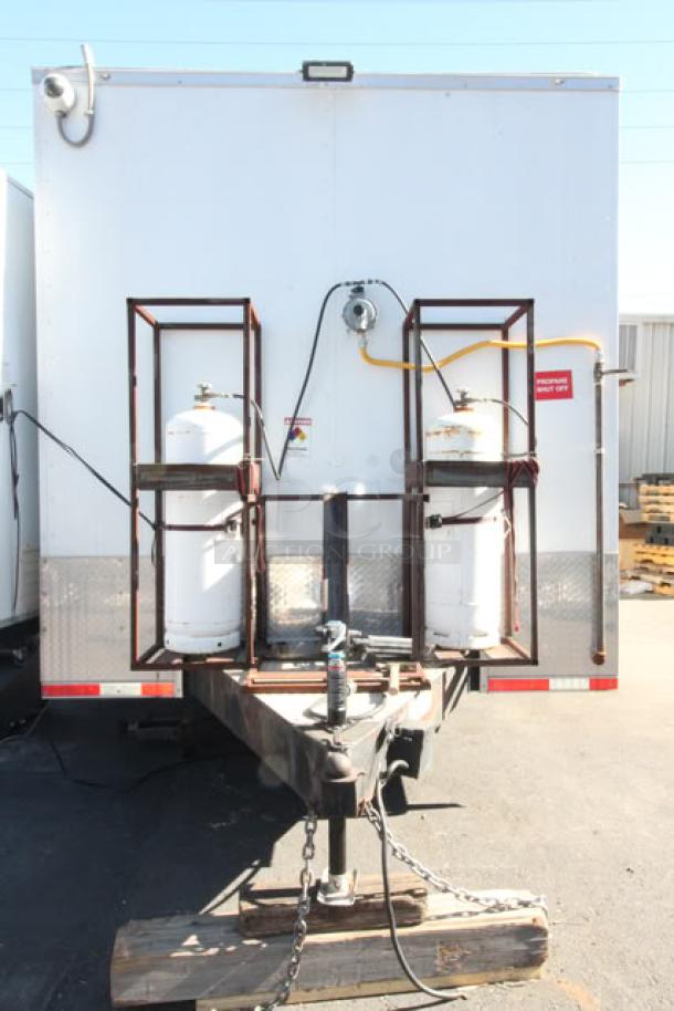 NEW Cruising Kitchens 24' Enterprise food trailer, propane tanks, ball hitch, LED lights, stainless steel interior, unused equipment.