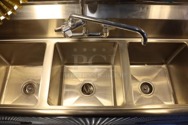 Stainless steel triple sink in new condition with sleek faucet, ideal for commercial use in food trailer setups.