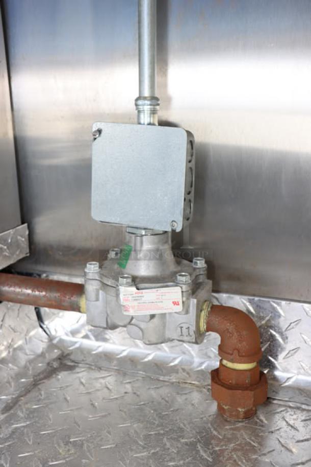 NEW Cruising Kitchens 24' Enterprise food trailer with stainless steel interior, showing propane hookup and electrical components.