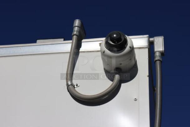 NEW Cruising Kitchens 24' food trailer, exterior security camera shown; includes wireless cameras, AC units, and propane tanks.