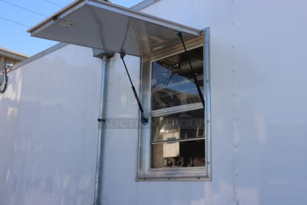 NEW Cruising Kitchens 24' food trailer, features rooftop AC units, propane tanks, LED lights, with stainless steel interior.