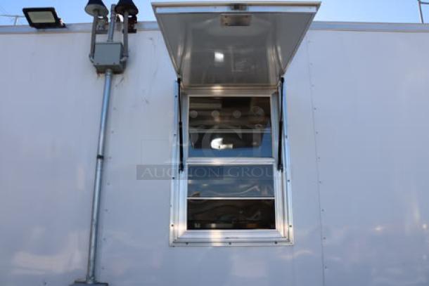NEW Cruising Kitchens 24' Enterprise Food Trailer, featuring a service window, rooftop air conditioning, and security camera.