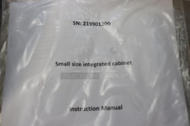 SN: 219901200 instruction manual for a small size integrated cabinet in clear plastic packaging.