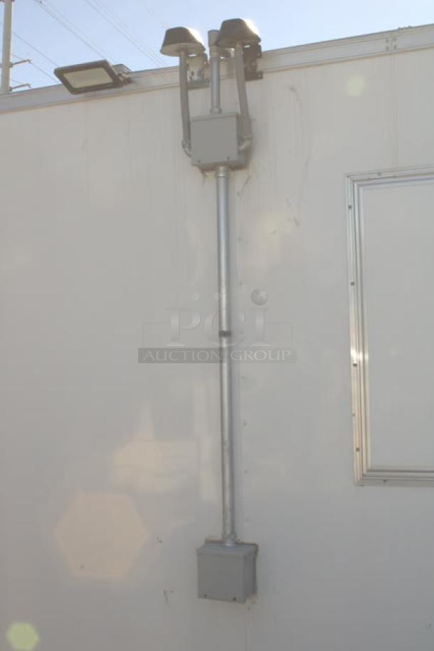 Exterior view of a NEW Cruising Kitchens 24' Enterprise Food Trailer. Features wireless security cameras, LED flood lights, and rooftop elements.