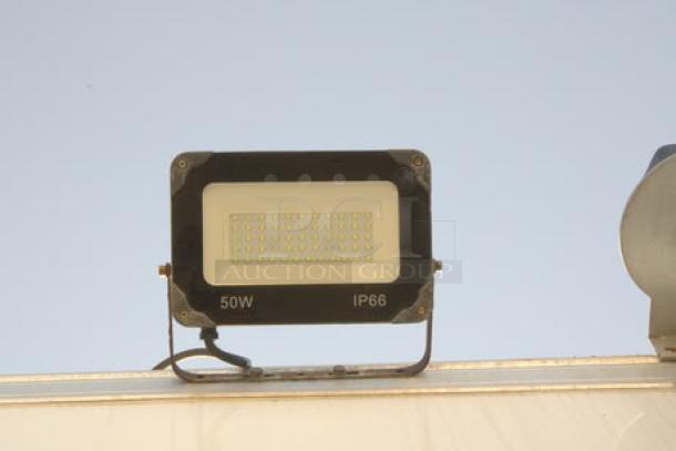 LED floodlight on the exterior of a Cruising Kitchens 24' Enterprise food trailer, marked 50W and IP66.