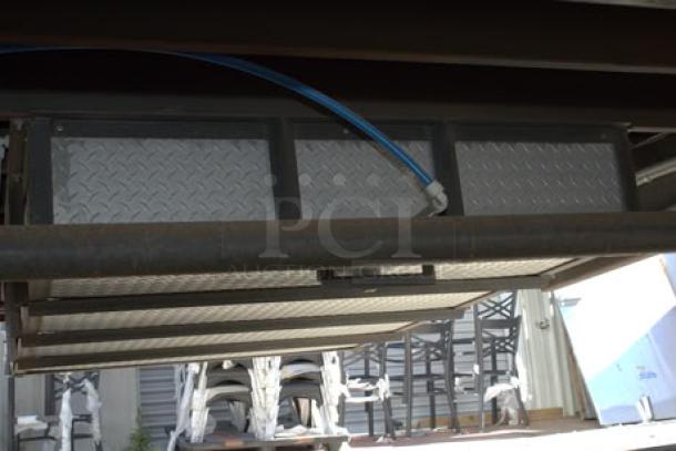 NEW Cruising Kitchens 24' food trailer underside, showing durable construction and utility connections.