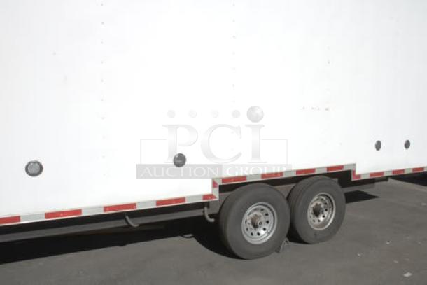 NEW 24' Cruising Kitchens food trailer, exterior view with tandem wheels, propane tanks, and LED flood lights.