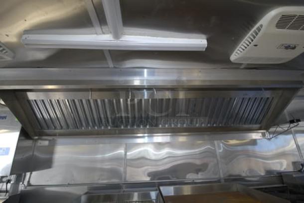 NEW Cruising Kitchens 24' food trailer with stainless steel interior, rooftop grease filter, and air conditioning unit.