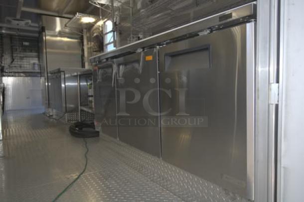 NEW 24' Enterprise food trailer, stainless steel interior, equipped with wireless security cameras, A/C units, propane tanks.