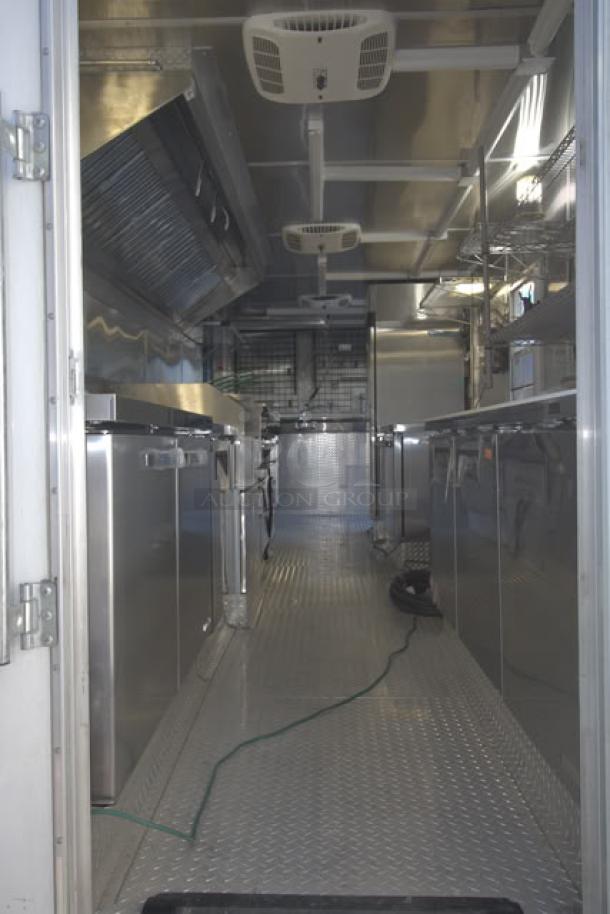 NEW 24' Cruising Kitchens food trailer, fully equipped, stainless steel interior, rooftop AC units, security cameras, and LED lights.