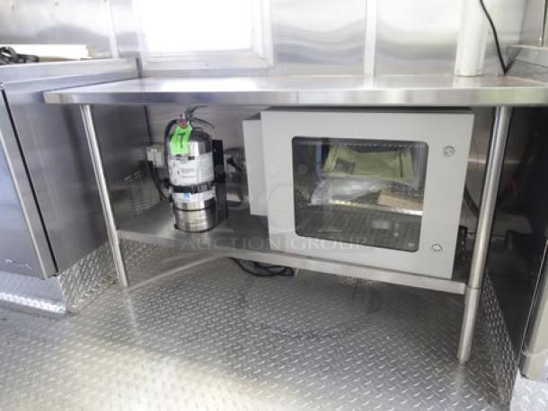 BRAND NEW 2023 Cruising Kitchens 24 Ft. Food Trailer, stainless steel interior, equipped with commercial-grade appliances.