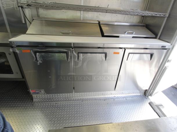 Brand new 2023 Cruising Kitchens 24 ft. Enterprise Food Trailer interior showing stainless steel commercial-grade coolers.