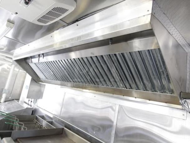 2023 Cruising Kitchens 24 Ft. Enterprise Food Trailer interior showing stainless steel 12ft hood with ANSUL system.