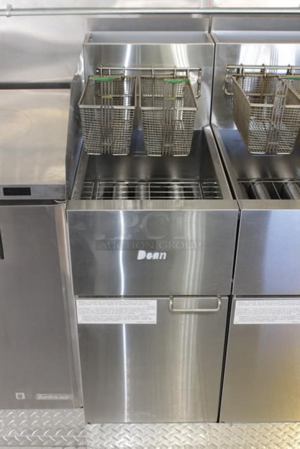 Stainless steel Dean deep fryer with dual baskets, part of a 2023 Cruising Kitchens 24 ft. mobile kitchen trailer setup.