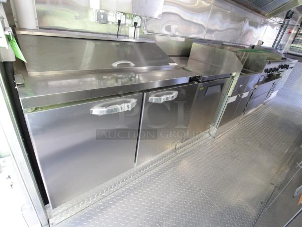 Brand new 24 ft. Cruising Kitchens mobile kitchen with stainless appliances, 12ft hood, and safety systems. Model: 1 - EK TRAILER - V12.