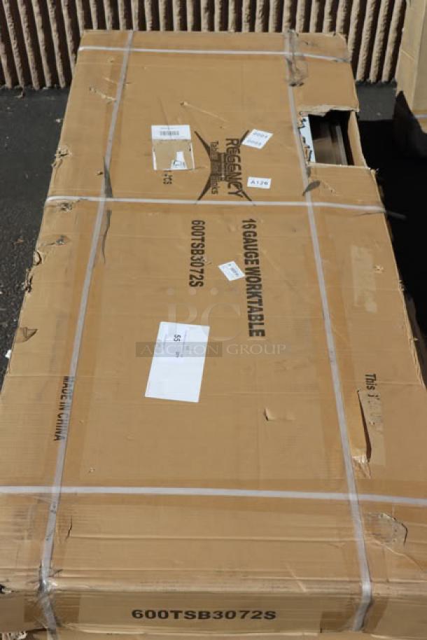 Regency 600TSB3072S stainless steel work table in packaging. Features 16-gauge steel, 30"x72", 4" backsplash, undershelf.
