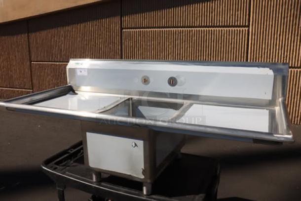 Regency 600S11723224 65" stainless steel commercial sink, one compartment, 2 drainboards, 17"x23"x12" bowl, new condition.