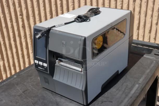 Zebra ZT411 industrial barcode printer, model ZT41142-T410000Z, in good condition. Serial number 99J242802106 visible.