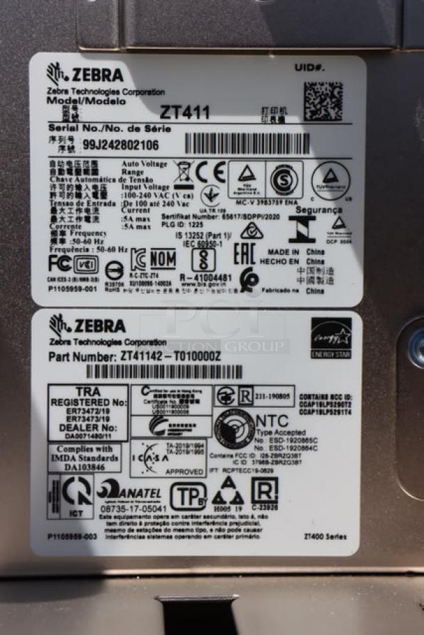 Zebra ZT411 industrial barcode printer, model ZT41142-T410000Z, serial number 99J242802106. Manufacturer labels shown.