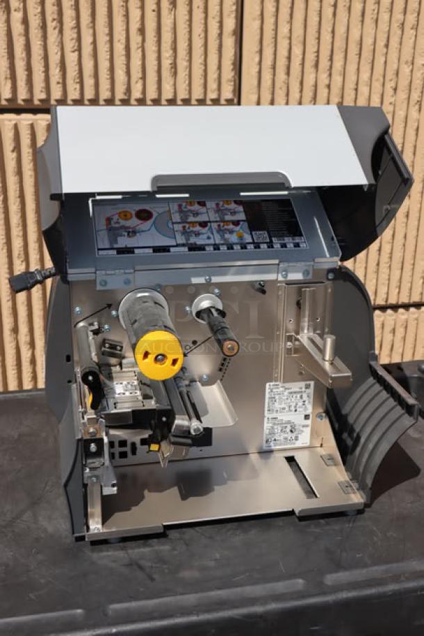 Zebra ZT411 industrial barcode printer, model ZT41142-T410000Z, open view, showing internal components and labels.