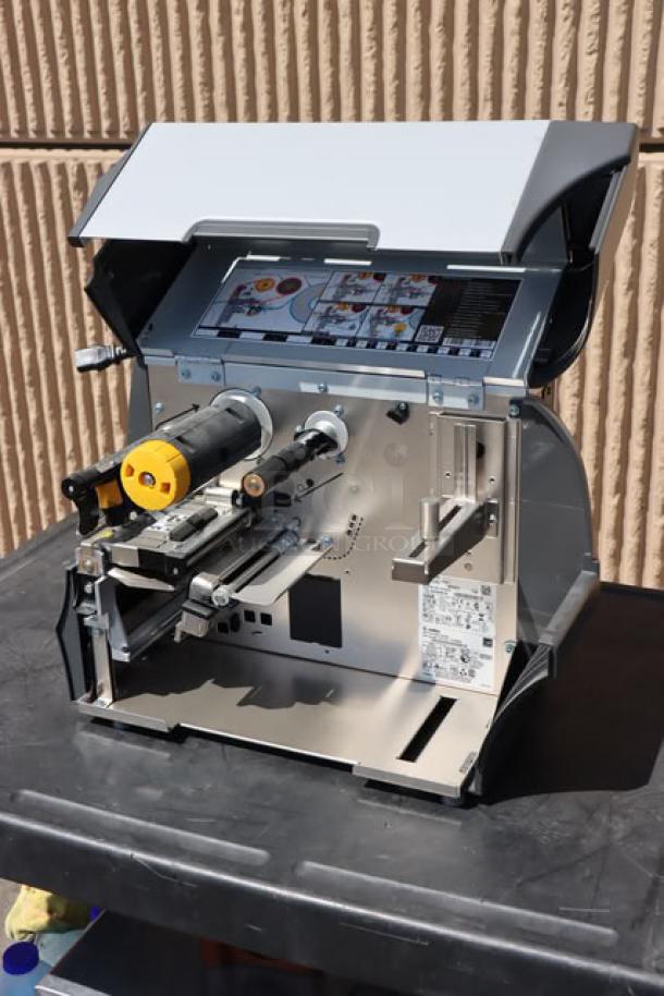 Zebra ZT411 Industrial Barcode Printer, model ZT41142-T410000Z, open view, showcasing internal components and label.