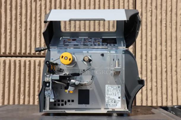 Zebra ZT411 Industrial Barcode Printer, model ZT41142-T410000Z, open for interior view, showing tech components and labels.