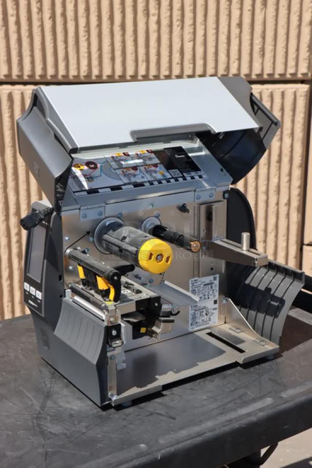 Zebra ZT411 Industrial Barcode Printer, model ZT41142-T410000Z. Open view showing internal components, black and gray finish.