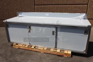 Brand new Regency 600EBTB3096D stainless steel table, 30"x96", enclosed base, sliding doors, adjustable midshelf, 6" backsplash.