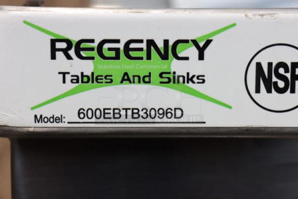 Regency stainless steel table with sliding doors, model 600EBTB3096D, featuring scratch-n-dent condition label.