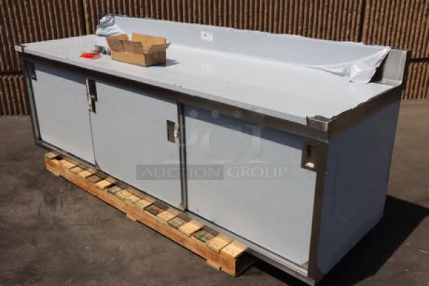 BRAND NEW SCRATCH-N-DENT Regency 600EBTB3096D stainless steel table, 30"x96", sliding doors, adjustable shelf, 6" backsplash.