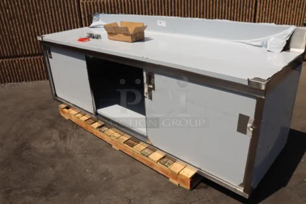 Regency 600EBTB3096D stainless steel table, 30"x96", enclosed base, sliding doors, adjustable midshelf, 6" backsplash. Brand new.