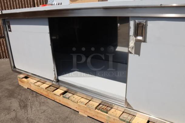 Brand new Regency 600EBTB3096D stainless steel table with enclosed base, sliding doors, midshelf, and 6" backsplash.